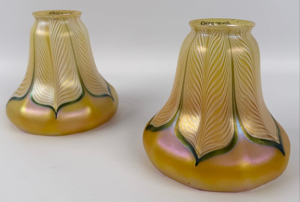 Pair Of Signed Quezal Art Glass Gold Iridescent Lamp Shades With Green & Pearl Pulled Feathers: Pair Of Signed Quezal Art Glass Gold Iridescent Lamp Shades With Green & Pearl Pulled Feathers. The shades have 2-1/8" fitters and are in good condition. Overall they measure approximately 5-1/8" tall