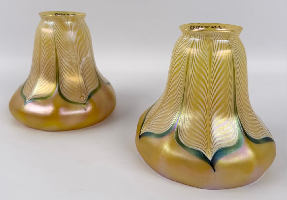 Pair Of Signed Quezal Art Glass Gold Iridescent Lamp Shades With Green & Pearl Pulled Feathers: Pair Of Signed Quezal Art Glass Gold Iridescent Lamp Shades With Green & Pearl Pulled Feathers. The shades have 2-1/8" fitters and are in good condition. Overall they measure approximately 5-1/8" tall