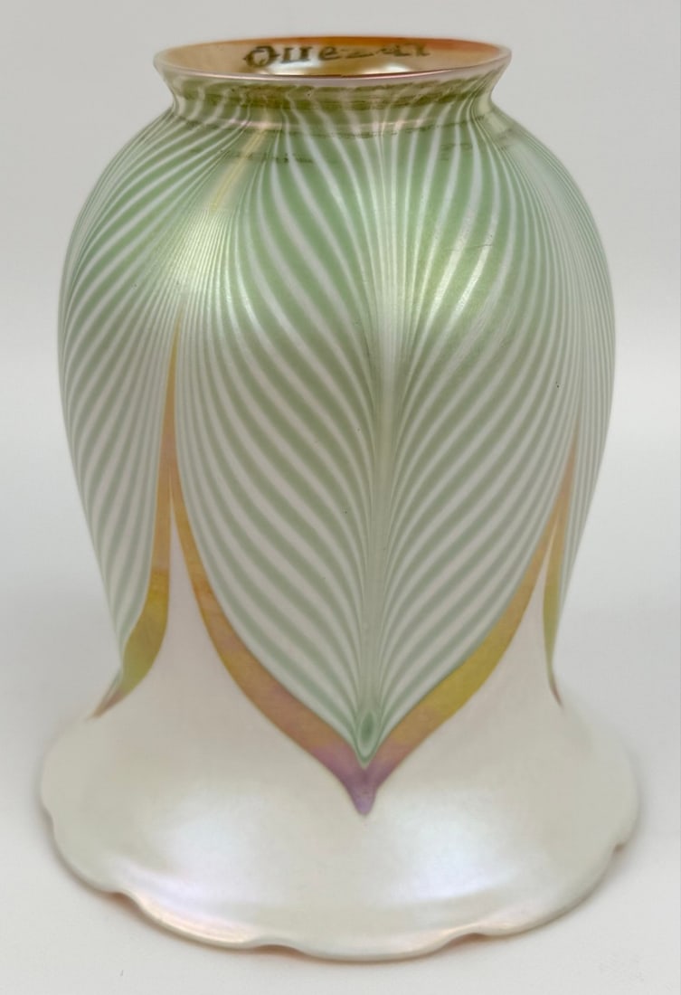 Signed Quezal Art Glass Pearl & Gold Iridescent Lamp Shade With Green Pulled Feathers: Signed Quezal Art Glass Pearl & Gold Iridescent Lamp Shade With Green Pulled Feathers. The shade has a 2-1/4" fitter and is in good condition. Overall measures approximately 5" tall x 4-1/4" across at