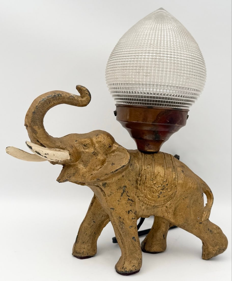 Vintage Brass Finish Art Deco Elephant Table Lamp: Vintage Brass Finish Art Deco Elephant Table Lamp. The spelter lamp has a brass finish and a Holophame prismatic glass acorn shade. The lamp has some finish wear, displays well. Measures approximately