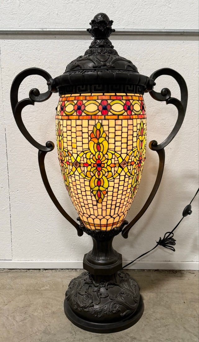 Contemporary Large Ornate Tiffany-Style Stained Glass Urn Floor Lamp: Contemporary Large Ornate Tiffany-Style Stained Glass Urn Floor Lamp. The lamp has a bronze tone resin frame with a a stained glass body in a Art Nouveau style. Displays very well. Measures approximat