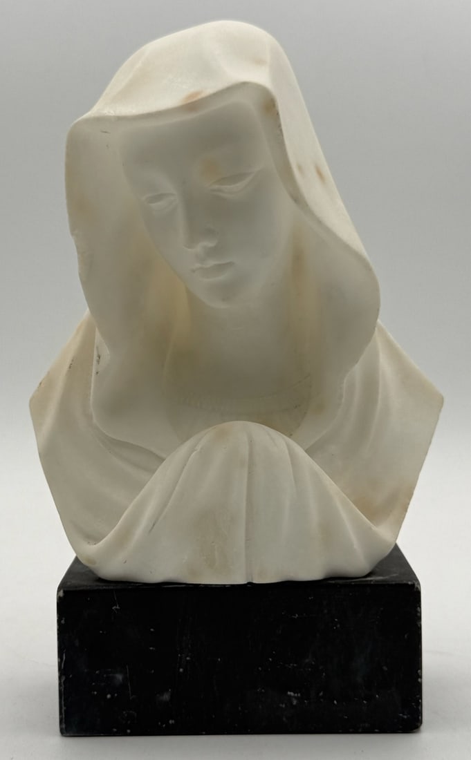 Antique Italian Alabaster Bust Of The Virgin Mary: Antique Italian Alabaster Bust featuring the Virgin Mary. The bust is in good condition on a black slate base, it has some dings. Measures approximately 8-1/4" tall x 5-1/4" across x 3-1/2" deep.