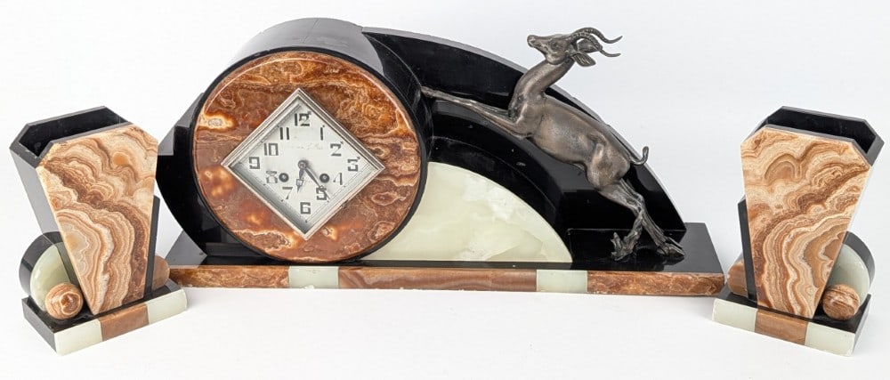 French Art Deco Marble & Slate Gazelle Clock With Planters: French Art Deco Marble & Slate Gazelle Clock With Planters. The clock comes with a F. Marti brass movement. The case is made of slate, marble and onyx and features a bronze tone metal gazelle. The mat