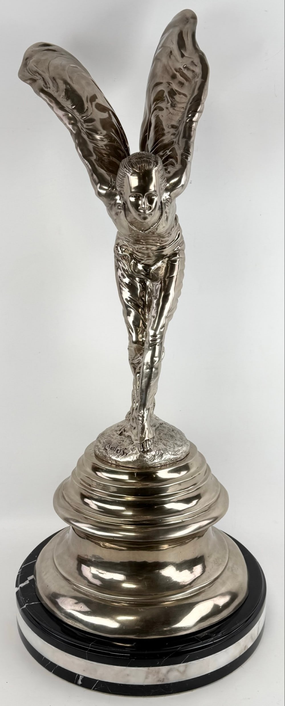 Spirit Of Ecstasy Silverplated Bronze Sculpture: Spirit Of Ecstasy Silver-Plated bronze sculpture on a triple marble base. The sculpture has great detail and is created after the Rolls Royce mascot. Measures approximately 32-3/4" tall x 14" across x
