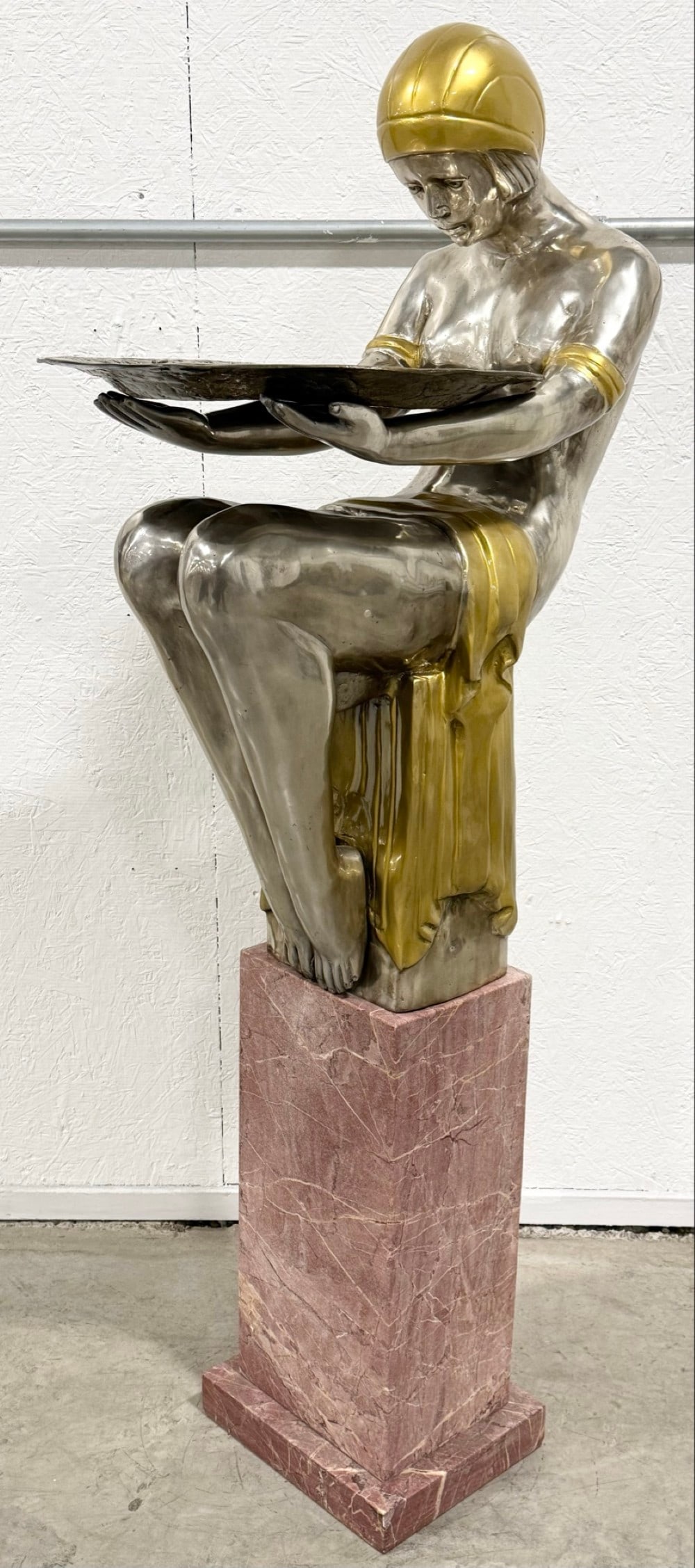 Art Deco Woman Holding Tray Silver-Plated Bronze Sculpture On Pink Marble Base: Art Deco Woman Holding Tray Silver-Plated Bronze Sculpture On Pink Marble Base. The sculpture features gold accents on the silver. Has great detail and quality workmanship. Overall the bronze measures