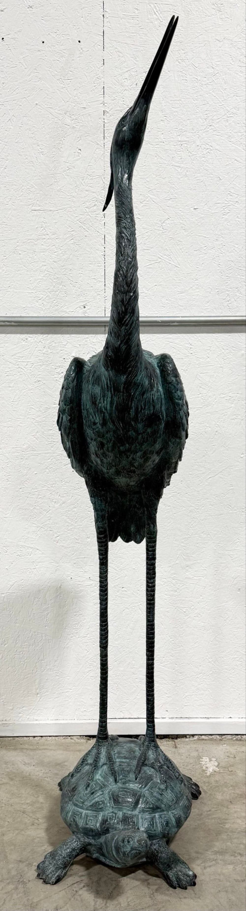 6 Foot Patinated Green Crane Standing On Turtle Bronze Fountain With Head Up: 6 Foot Patinated Green Crane Standing On Turtle Bronze Fountain With Head Up. The fountain has great detail and workmanship. Overall the fountain measures approximately 16" across x 71-1/2" tall x 22"