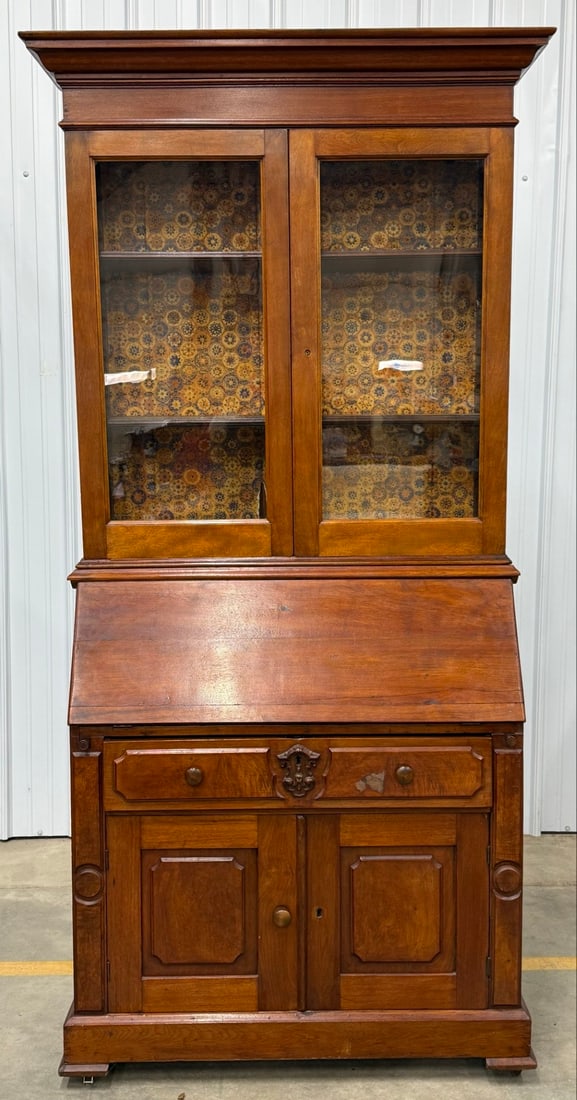 Antique Victorian Walnut Eastlake Secretary Bookcase Desk: Antique Victorian Walnut Eastlake Secretary Bookcase Desk. The bookcase section has wavy glass doors that sits on a slant front writing desk with cubbyholes.The base has two doors and a drawer.? Displ