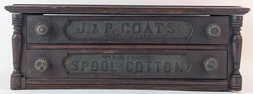 Antique J.& P. Coat's Two Drawer Spool Cabinet: Antique J.& P. Coat's Two Drawer Spool Cabinet. The cabinet features four bronze drawer pulls and an embossing design on the drawers. Good condition with age and use wear. Overall measures 8" tall x 2