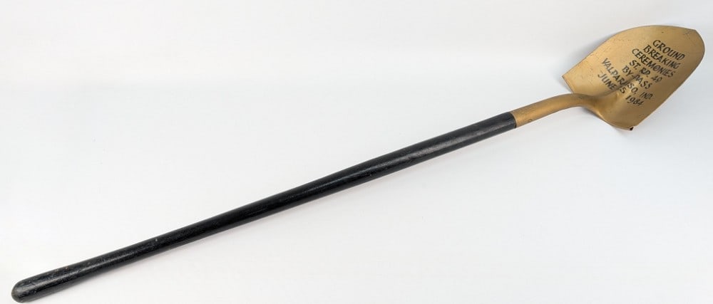 June 25, 1984 St. Rd. 49 By-Pass Valparaiso, Ind. Ground Breaking Ceremonies Shovel: June 25, 1984 St. Rd. 49 By-Pass Valparaiso, Ind. Ground Breaking Ceremonies Shovel. The shovel shows some storage wear and is gold painted with a wooden handle. Measures approximately 56-1/2" long x