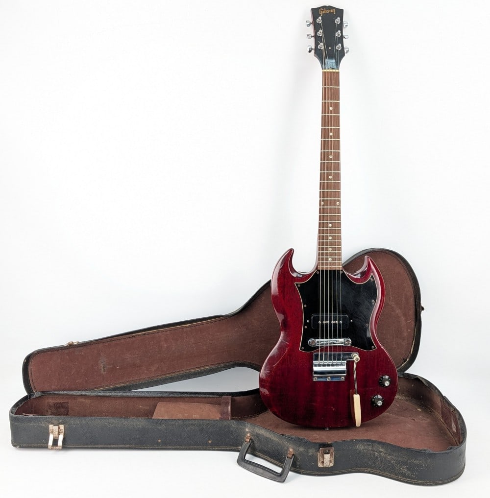 1966 Gibson SG Junior Large Guard Electric Guitar In Vintage Cherry: 1966 Gibson SG Junior Electric Guitar. The vintage cherry guitar features the large guard, mahogany body and neck, rosewood fingerboard, master volume, master tone, and vibrola tremola. Nice guitar wi