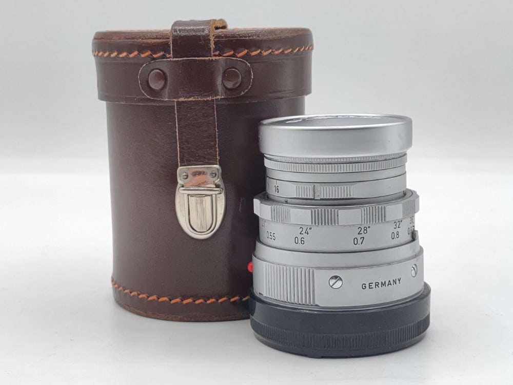 Ernst Leitz (Leica) 5cm f/1.2 Summicron Camera Lens: Ernst Leitz (Leica) 5cm f/1.2 Lens. The silver lens appears to be in good used condition with the original Leica cap in a leather case. Serial #1764607.