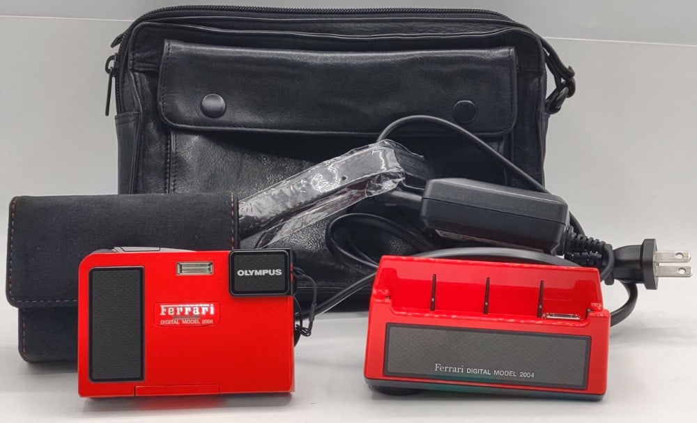 Rare Olympus Ferrari Model 2004 3.2MP Limited Edition Digital Camera: Rare Olympus Ferrari Model 2004 3.2MP Limited Edition Digital Camera. Serial number 02910. Comes with the charging cradle, Ferrari case, cord, and strap. The camera works and is in like new condition.