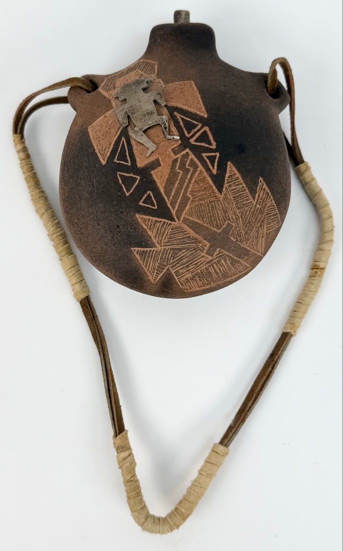 Nora Naranjo-Morse Santa Clara Tewa Pueblo Earthenware Pottery Canteen: Santa Clara New Mexico Earthenware Pottery Canteen by listed Tewa Pueblo artist Nora Naranjo-Morse (Born 1953). The pottery canteen is titled "Nora's Canteen" and has an attached silver figure & stopp