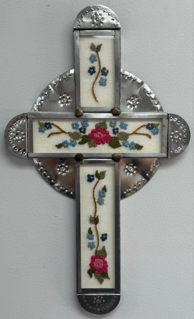 1994 Colcha Stitched Tin & Brass Cross By Artist Donna Wright de Romero: Colcha Stitched Tin & Brass Cross by New Mexico artist Donna Wright de Romero. The tin cross with glass covered embroidery has brass rivets and is signed on the verso. Good condition with no visible d