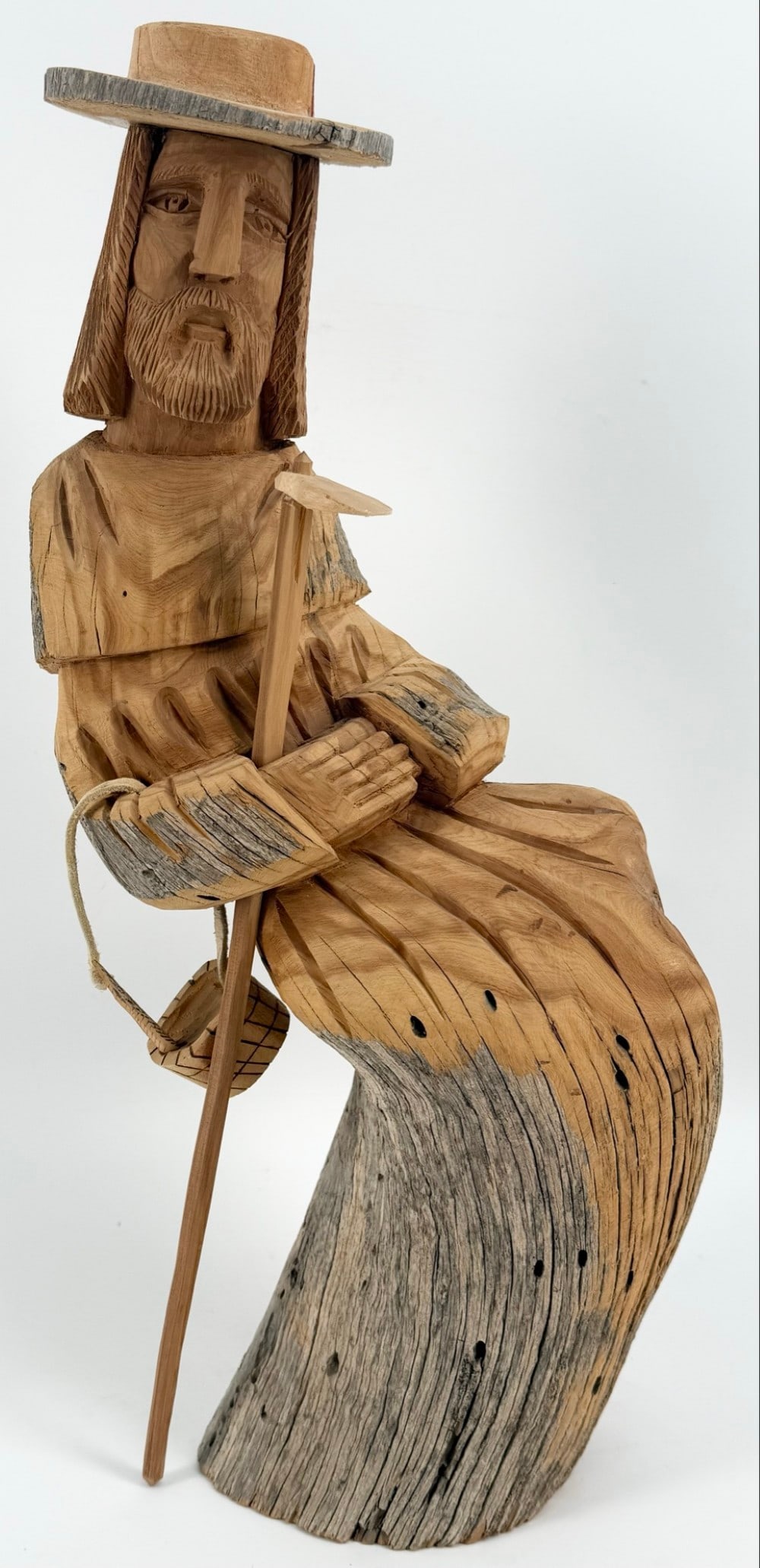 1996 Leonardo Salazar "St. Francis" Hand-Carved Cedar Wood Figure: Large hand-carved cedar wood figure by award winning Taos New Mexico artist Leonardo Salazar. The figure features "St. Francis With A Hoe & Gathering Basket" and is signed and dated on the base. Displ