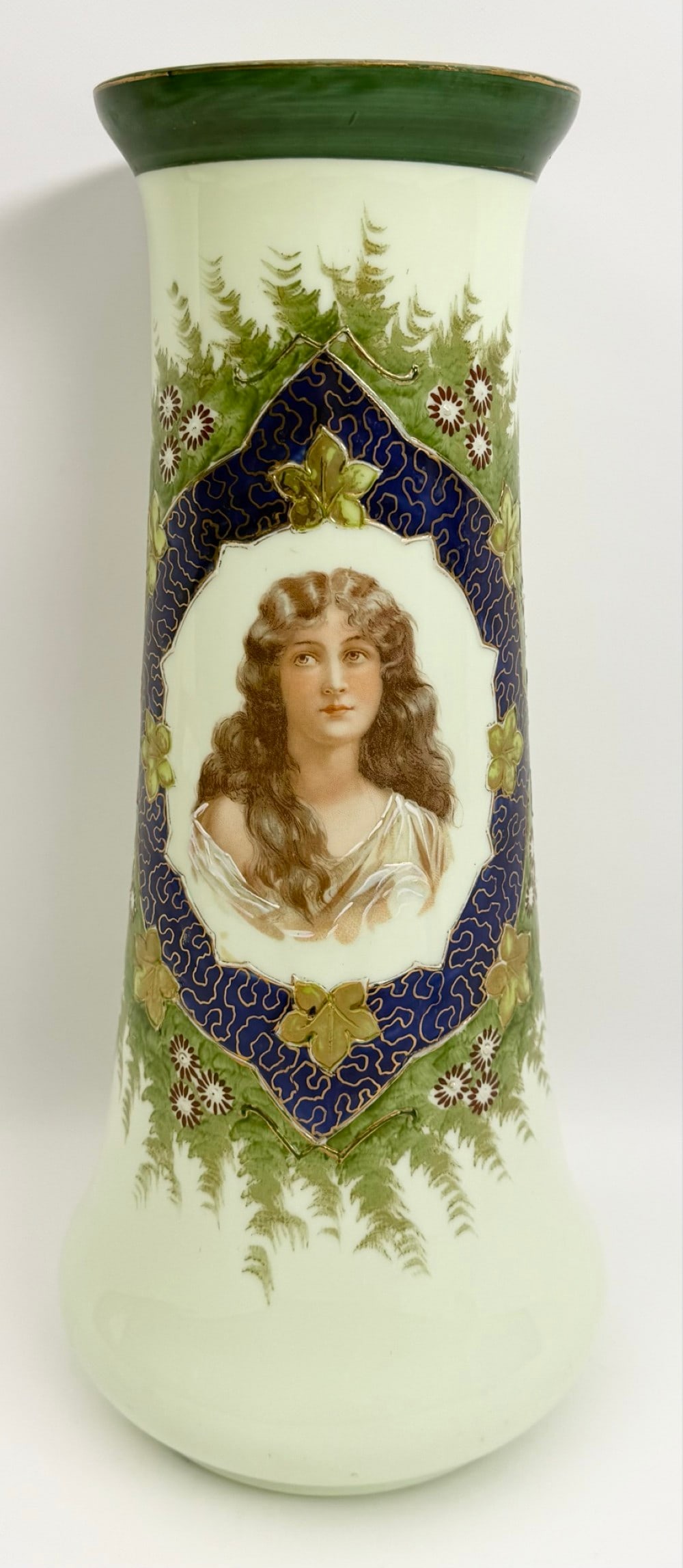 Large Antique Custard Opaline Glass Portrait Vase: Vintage Custard Opaline Glass Portrait Vase. The vase features a center transfer portrait of a young woman surrounded by a hand-painted blue border with gold accents and leaves with flowers. Good cond