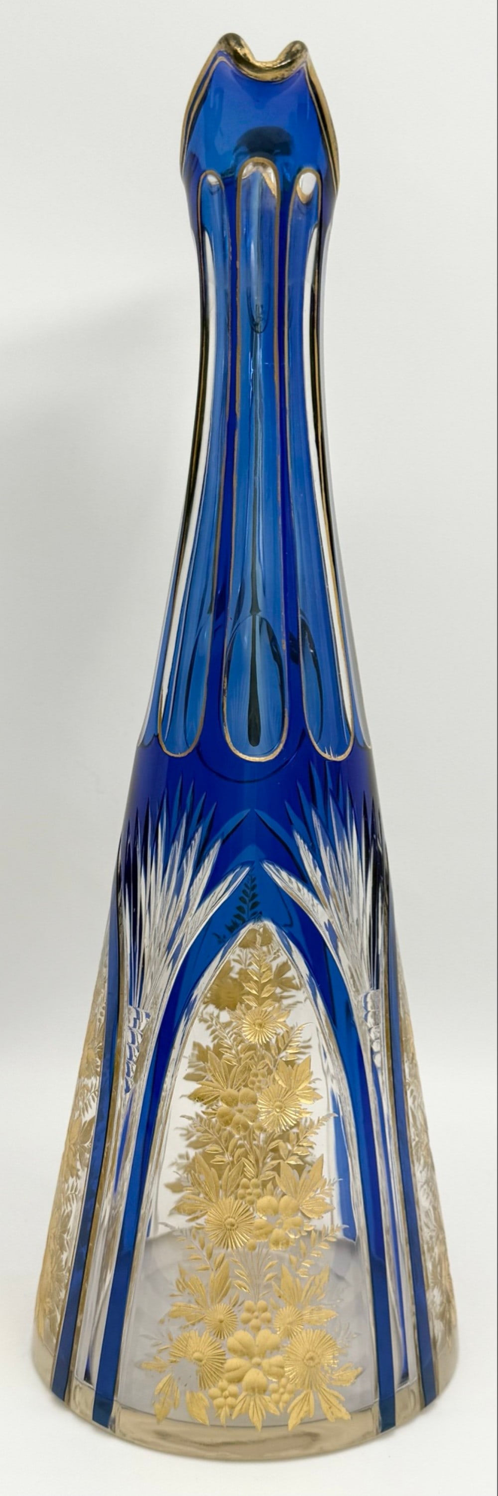 Vintage Murano Cobalt Blue Cut To Clear Glass Ewer: Vintage Murano Cobalt Blue Cut To Clear Glass Ewer. The ewer features an arch design with gold accented flowers. Good vintage condition with some wear to the gold accents. Measures approximately 12-1/