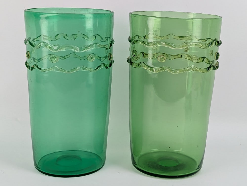 Pair Of Mid-Century Murano Green Glass Vases: Pair Of Mid-Century Murano Green Glass Vases. The vases have an applied double ribbon with dots wrapping around the vases. They display well with no chips or cracks. They measure approximately 13-1/2"