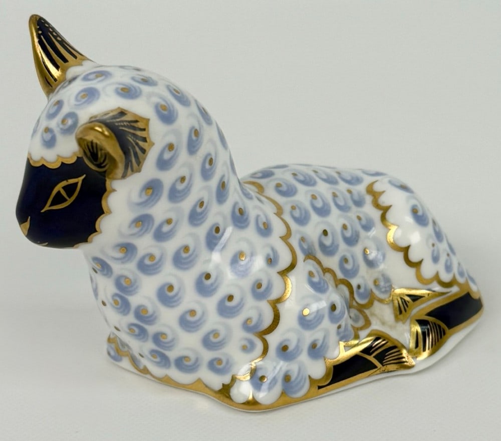 Royal Crown Derby Bone China Lamb Paperweight: Royal Crown Derby Bone China Lamb Paperweight. The English made paperweight figurine is in great condition and is hallmarked on the base. Measures approximately 2-3/4" tall x 3-3/4" across x 2" deep.