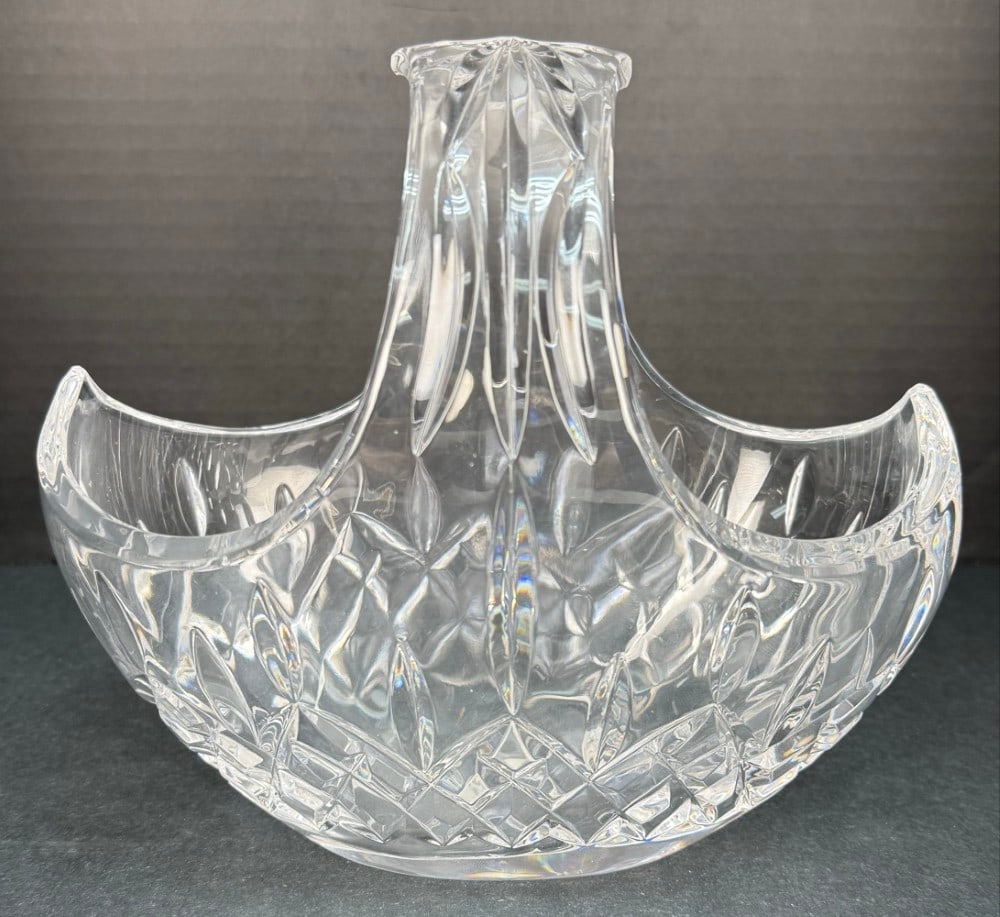 New In Box Waterford Crystal Lismore Basket: Waterford Crystal Lismore Basket. The basket is in new unused condition in the original box with the sticker. Measures approximately 6-3/4" tall x 7-1/2" across.
