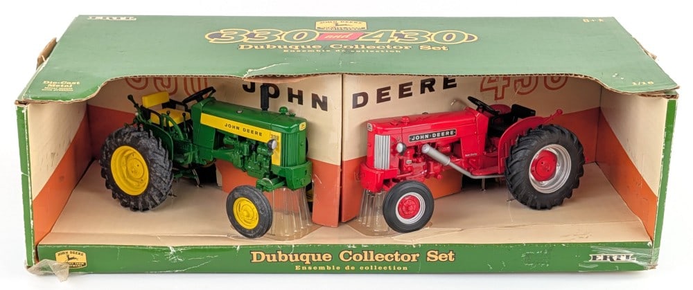 1/16 Ertl John Deere 330 and 430 Tractors Dubuque Collector Set: 1/16 Ertl John Deere 330 and 430 tractors. Dubuque Collector Set. Includes a green John Deere 330 and red John Deere 430. Good condition in the box. The box shows light wear.