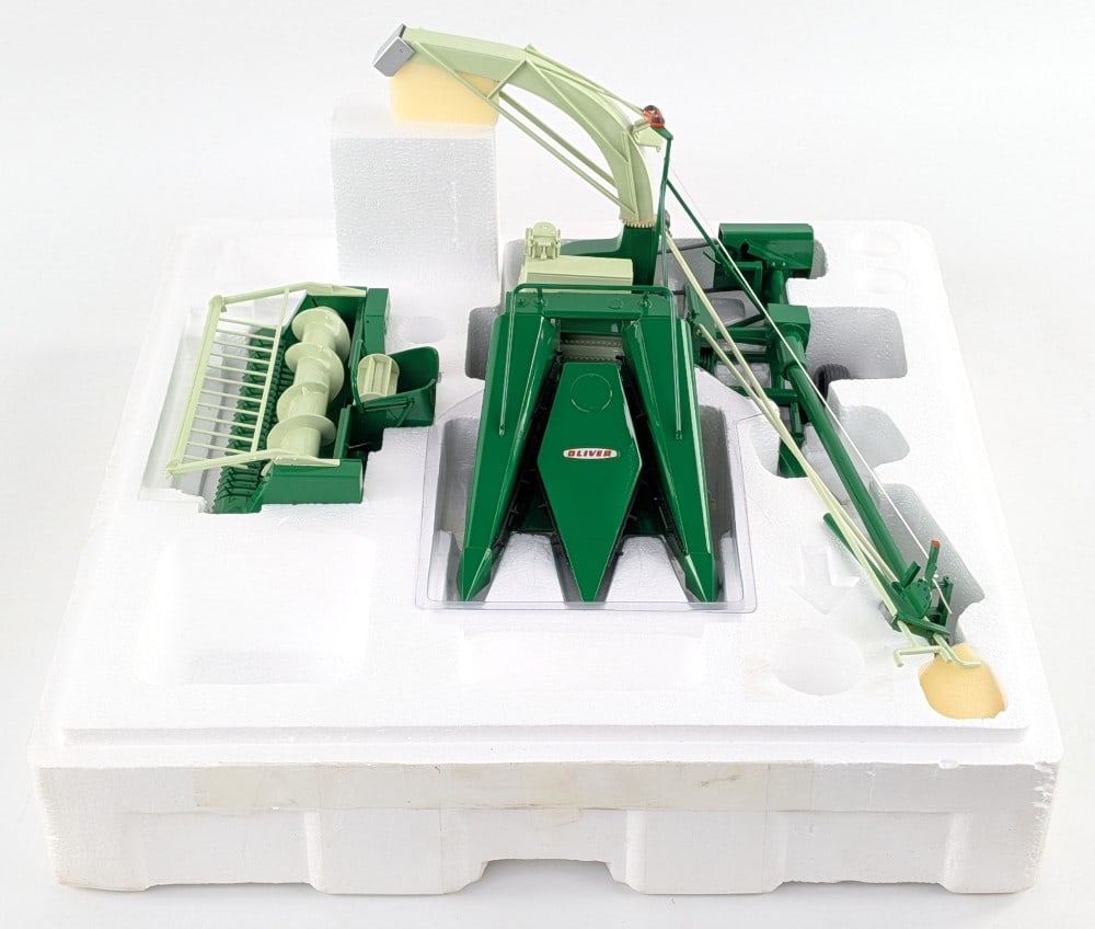 1/16 SpecCast Oliver Forage Harvester with Corn and Hay Head: 1/16 SpecCast Oliver forage harvester with corn and hay head. A very unusual implement that you rarely find. It does have a repair to the post that holds the white control arms and string. Otherwise i
