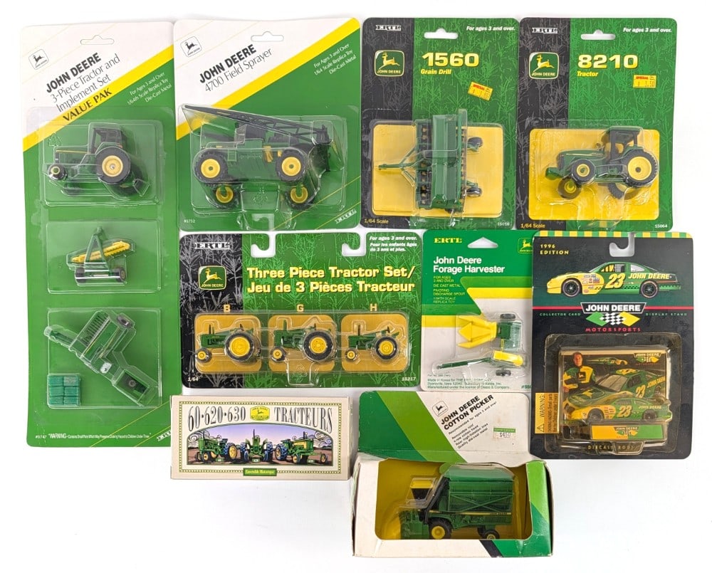 1/64 Ertl John Deere Tractors & Implements: Includes John Deere Cotton Picker, B G and H tractor set, grain drill, field sprayer, and tractors. Good condition in the packages.