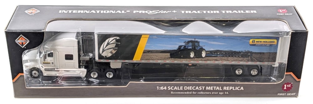 1/64 First Gear International Semi Truck w/ New Holland Agriculture Trailer: 1/64 First Gear International Semi truck with New Holland agriculture van trailer. The truck and trailer are new in the box. The box has some dust and wear from handling / storage.