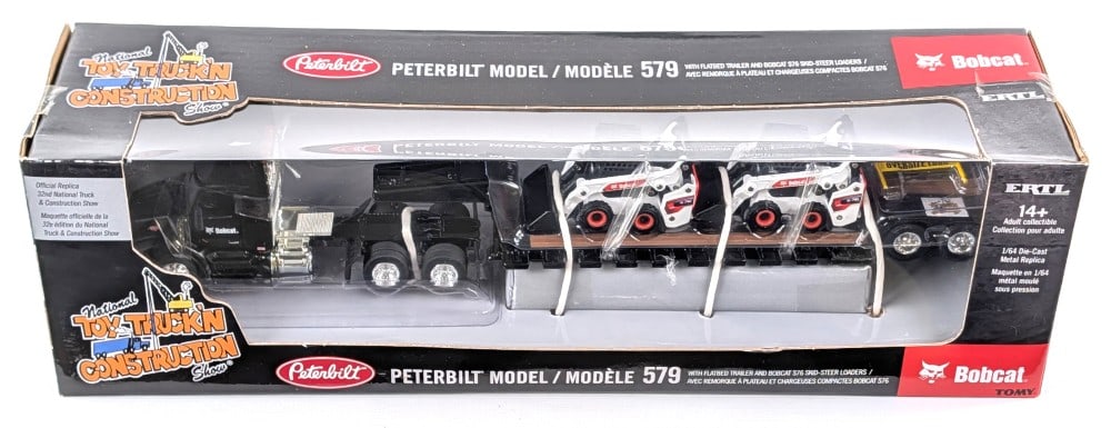 1/64 Ertl Peterbilt Model 579 w/ Flatbed Trailer and Bobcat Skid Steer Loaders: 1/64 Ertl Peterbilt Model 579 semi truck with flatbed trailer and Bobcat S76 skid steer loaders. Official replica for the 32nd National Truck & Construction Show. Good condition new in the box. The bo
