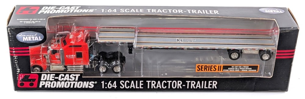 1/64 DCP Kory Kenworth W900 Truck w/ Spread-Axle Step Deck Trailer: 1/64 scale Die-Cast Promotions Kory Farm Equipment Kenworth W900 semi truck with spread-axle step deck trailer. Good condition new in the box and highly detailed.