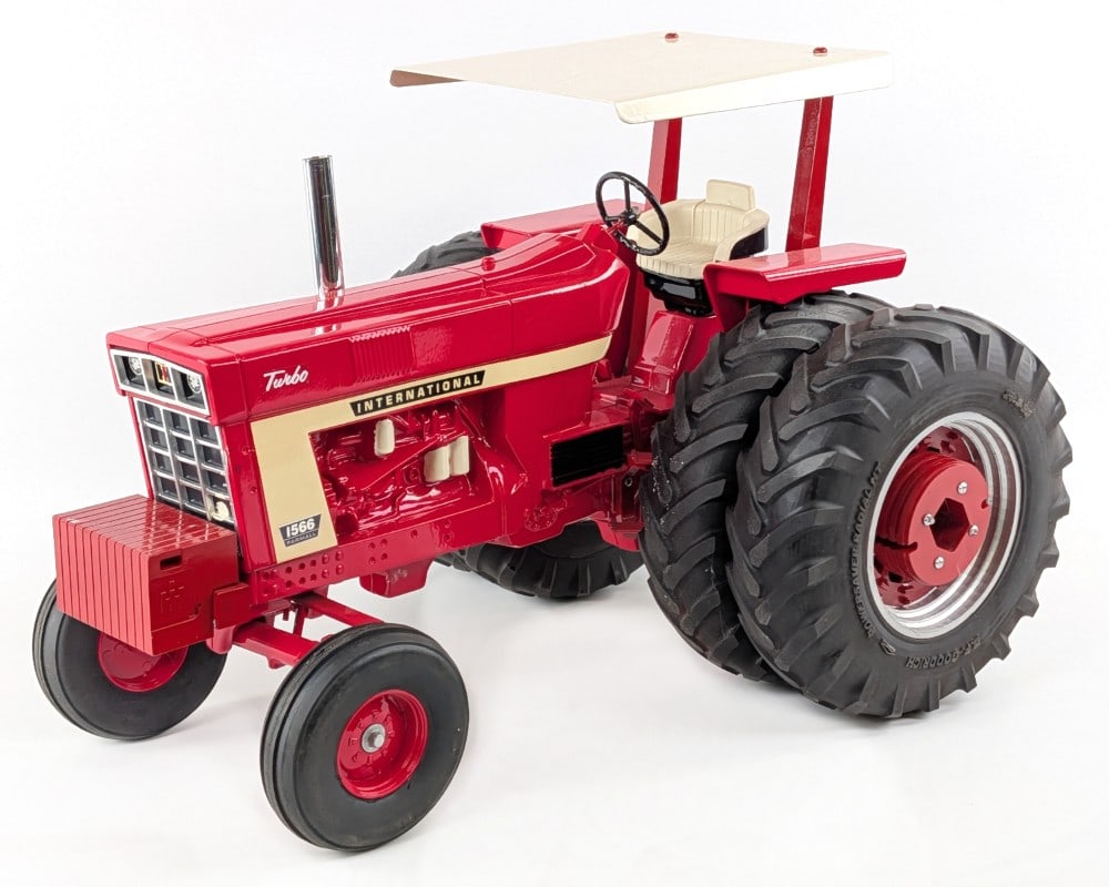 Custom 1/8 Scale International 1566 Tractor w/ Duals & Canopy: Custom 1/8 scale International 1566 tractor with duals and canopy. The tractor has custom tires, suitcase weights, canopy, and chrome stack. It does have a scratch on the top of the canopy and rub mar