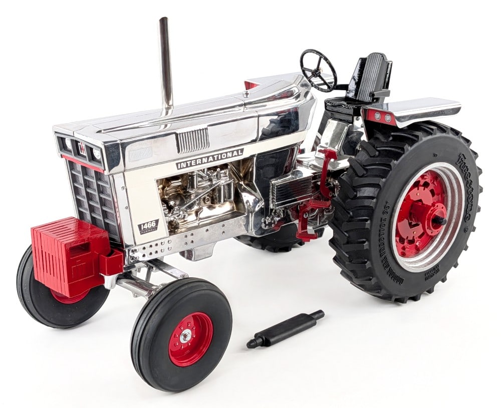 Chrome Custom 1/8 Scale International 1466 Tractor: Chrome custom 1/8 scale International 1466 wide front tractor. The tractor displays well with custom tires, suitcase weights, chrome stack, and a shiny chrome finish. Good condition overall and displa