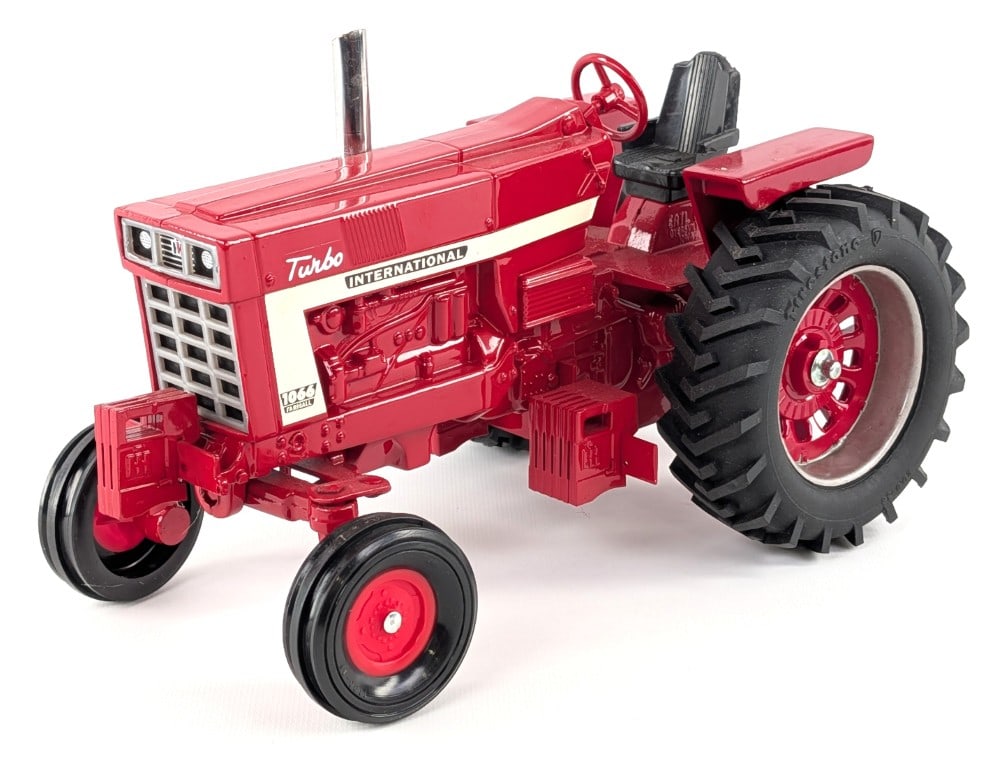 Custom 1/16 International Farmall 1066 Turbo Pulling Tractor: Custom 1/16 International Farmall 1066 turbo pulling tractor. The tractor displays well with custom tires, chrome stack, and loaded up with suitcase weights. Good condition with light dust from displa