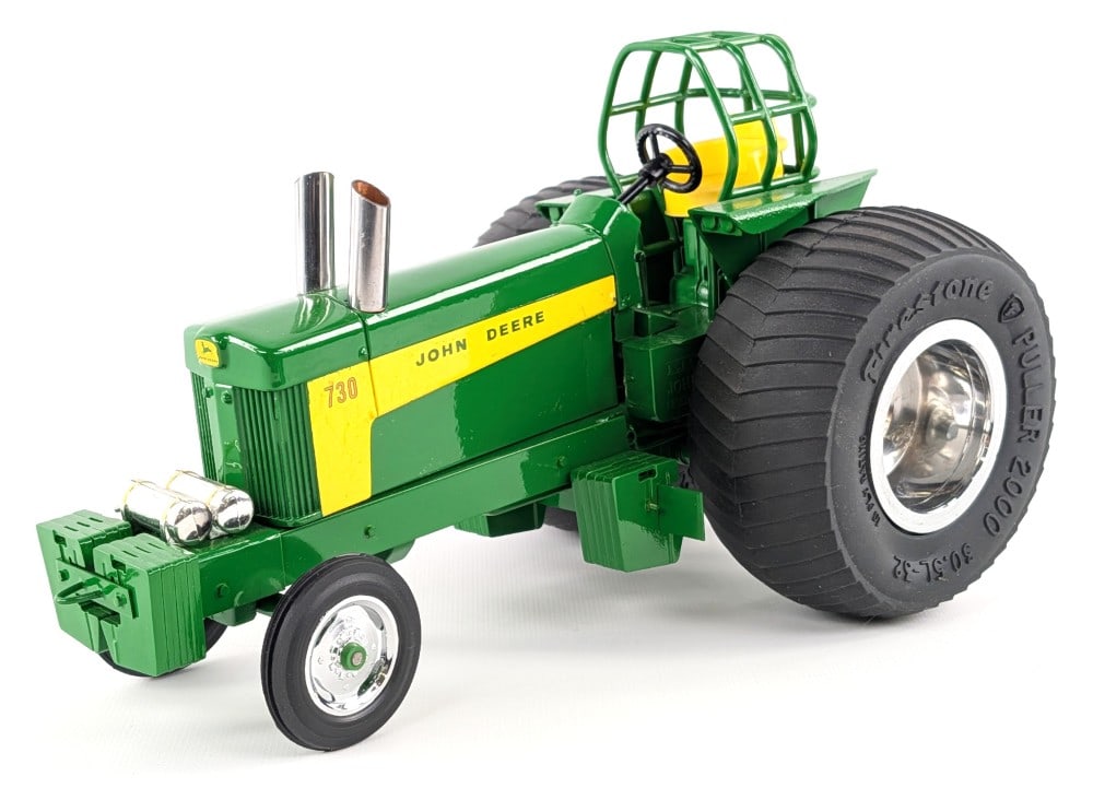 Custom 1/16 John Deere 730 Pulling Tractor: Custom 1/16 John Deere 730 pulling tractor. A very nice high quality customization. Displays well with chrome wheels, custom tires, roll cage, and suitcase weights. The tractor does have some crazing