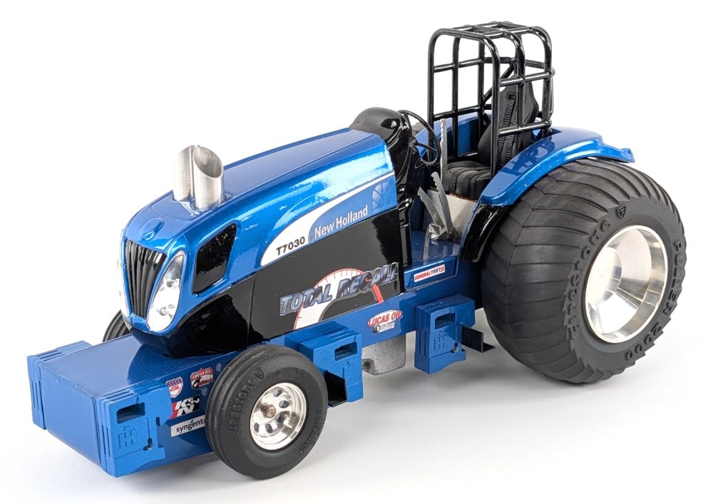 Custom 1/16 New Holland T7030 "Total Recall" Pulling Tractor: Custom 1/16 New Holland T7030 "Total Recall" pulling tractor. The tractor is a very nice highly detailed Custom Displays well with chrome features, suitcase weights, wheelie bar, roll cage, and great