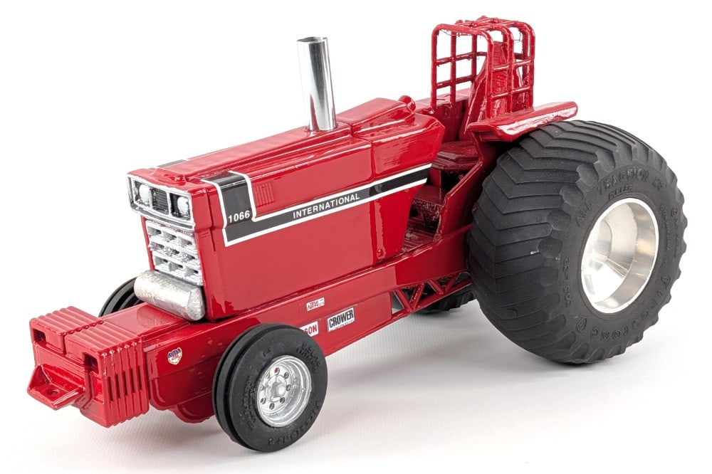 Custom 1/16 International 1066 Pulling Tractor: Custom 1/16 International 1066 pulling tractor. The tractor has custom tires, chrome exhaust, roll cage, and suitcase weights. The foot rest area shows some crudeness as well as the back wheelie bar.