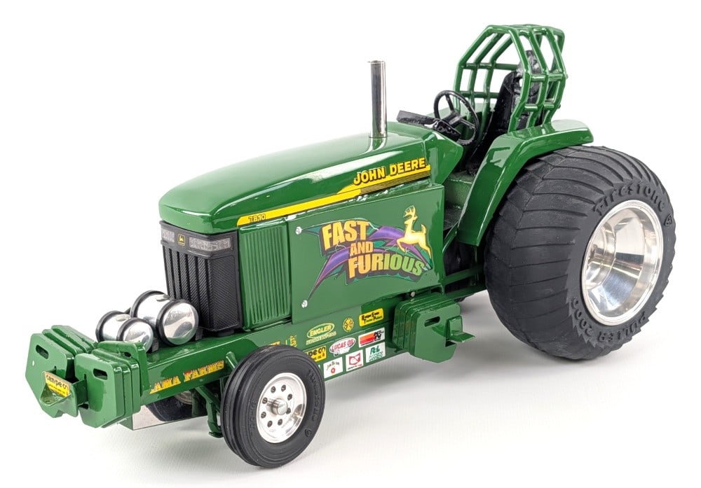 Custom 1/16 John Deere 7810 "Fast and Furious" Pulling Tractor: Custom 1/16 John Deere 7810 "Fast and Furious" pulling tractor. The tractor displays well with custom tires, wheelie bar, roll cage, suitcase weights, chrome features, and great detail. Good condition