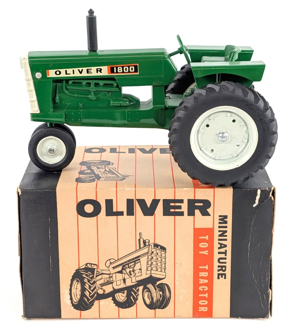 1/16 Ertl Oliver 1800 Narrow Front Tractor w/ Box: Vintage 1/16 Ertl Oliver 1800 narrow front tractor with the original box. The box is missing one of the inside flaps and has some tape repairs. The tractor has some tiny chips on the grill, but is in