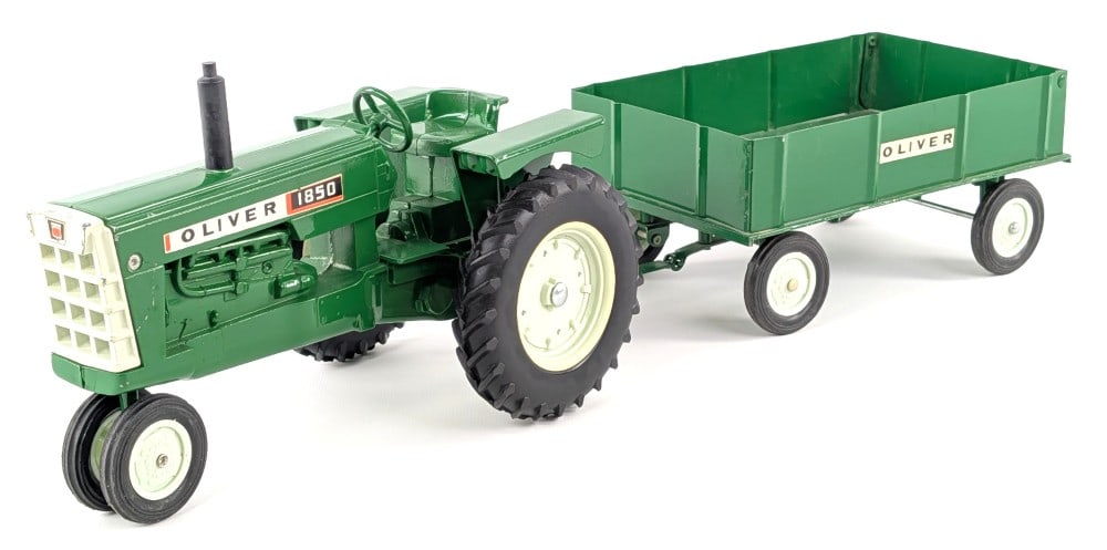 1/16 Ertl Oliver 1850 Narrow Front Tractor and Barge Wagon: Vintage original 1/16 Ertl Oliver 1850 narrow front tractor and barge wagon. The tractor has some paint chips on the grill area, but otherwise is in good condition. The wagon is in very good condition