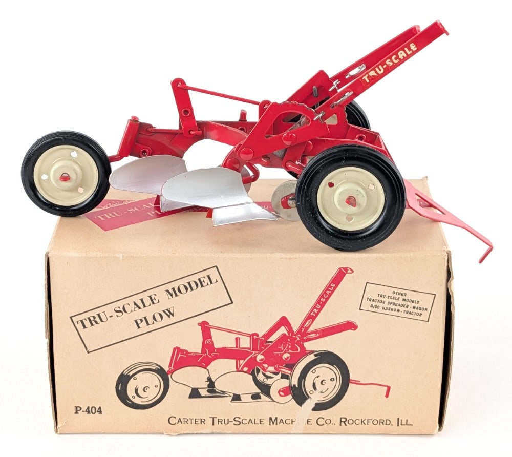 1/16 Tru-Scale 2-Bottom Plow w/ Box: 1/16 Tru-Scale 2-bottom plow with the original box. The plow has a minor blemish to the Tru-Scale decal. The box is very clean and square. It does have some peeling to the underside of the box.