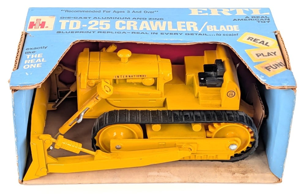 1/16 Ertl International TD25 Crawler w/ Blade in Blue Box: Vintage 1/16 Ertl International TD25 crawler with blade in the original blue box. The crawler is new in the box with a minor rub mark on the blade arm. The box is overall very straight and has bright