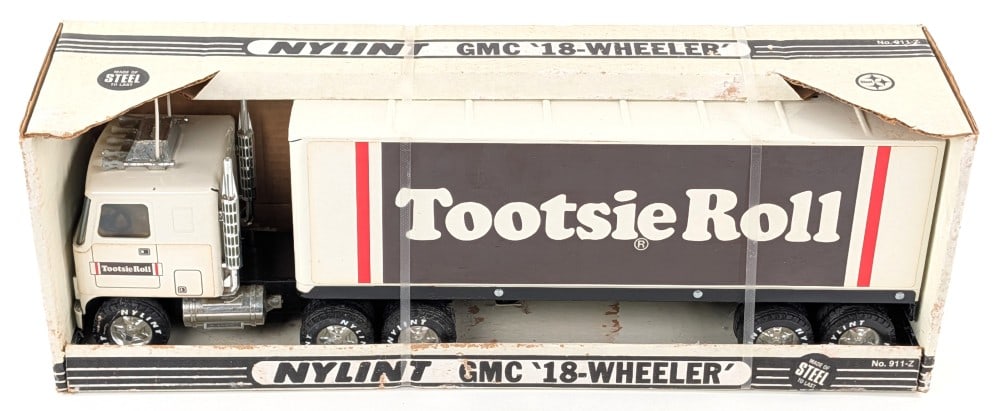 Nylint GMC Cabover Tootsie Roll Semi Truck & Trailer: Nylint GMC cabover Tootsie Roll 18-wheeler semi truck and trailer. The truck has a small paint chip on th ecab and minor discoloration to the decals. The box has some flaking and wear from storage. Me