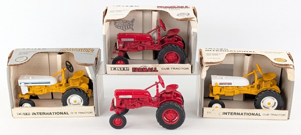 (4) 1/16 Ertl International Farmall Cub Tractors: (4) 1/16 Ertl International Farmall Cub tractors. Three of the tractors are in the original boxes and one is loose. All are in good condition with light dust from storage.