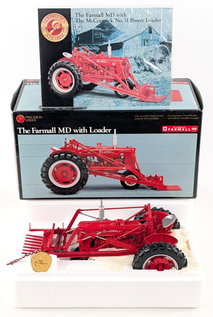 1/16 Ertl Precision Series #10 Farmall MD Tractor with Loader: 1/16 Ertl Precision Series #10 Farmall MD tractor with loader. The tractor has some minor dust from being on display, but otherwise is in good condition in the box. It comes with the booklet and medal