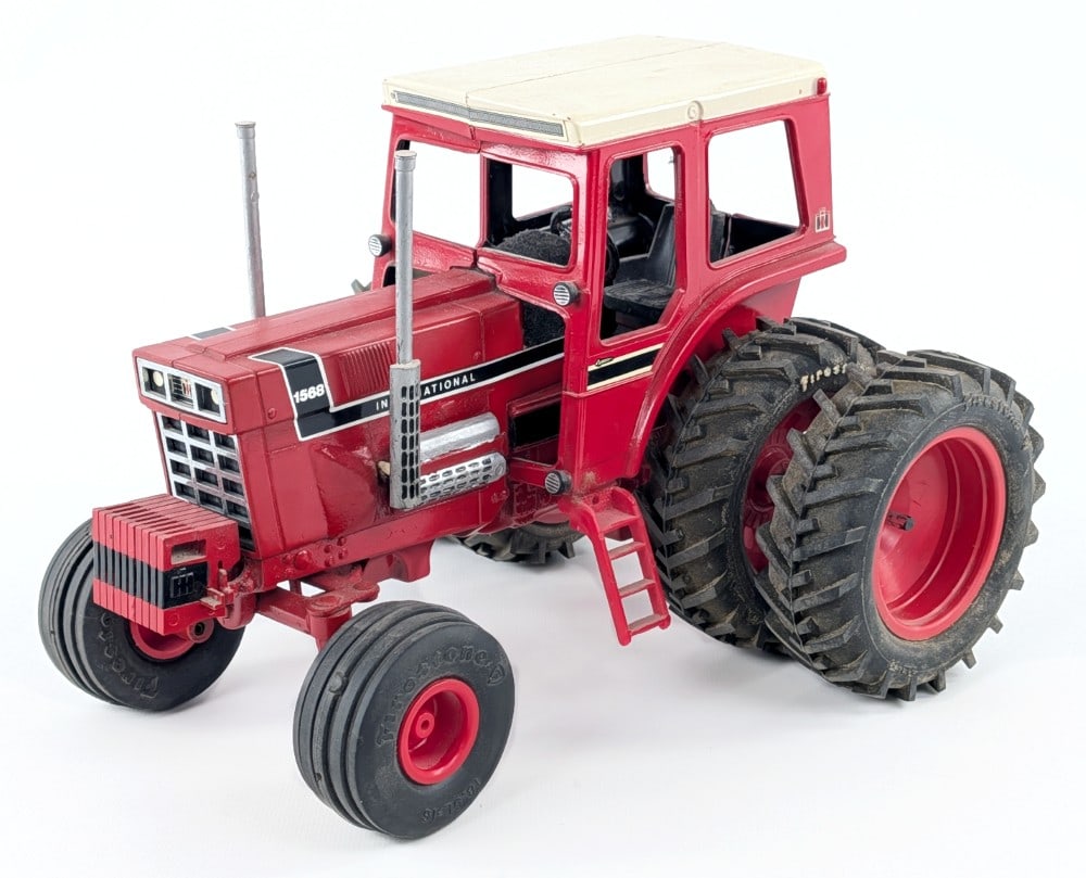 Custom 1/16 International 1568 V8 Tractor: Custom 1/16 International 1568 V8 tractor. Definitely an older custom piece. The cab of the tractor is loose. The tractor has custom Firestone tires, suitcase weights, and V8 engine. The tractor has d
