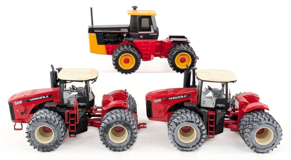 1/32 Versatile 550, Versatile 500, and Versatile 1156 Tractors: 1/32 Ertl Versatile 550 tractor, Versatile 500 tractor, and Scale Models Versatile 1156 tractor. The Versatile 550 has a broken railing. All have some dust and light wear from handling / display.