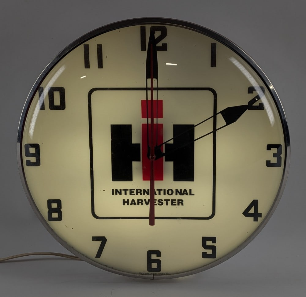 2003 International Harvester Pam Style Lighted Advertising Clock: Contemporary 2003 International Harvester pam style lighted advertising clock. The clock lights up, but currently isn't running. It has some dust and light wear from storage / display. Measures approx