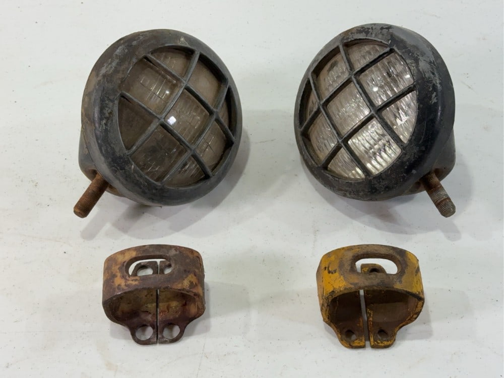 Caterpillar Headlights: Set of two headlights with mounting brackets, one has crack in the glass