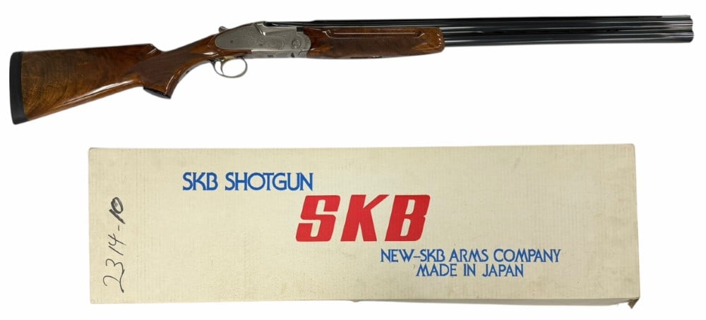 SKB Model 885 12 Gauge Over and Under Shotgun with case: SKB Model 885 12 Gauge Over and Under Shotgun with case.? The vent ribbed barrels are marked 3U SP88200 measure 30 inches in length and have screw in chokes installed shooting 3" shells. Bluing is in