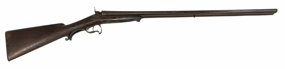 Unknown Manufacture Side by Side 20 Ga. Black Powder Shotgun Wall hanger: Unknown Manufacture Side by Side Black Powder Shotgun Wall Hanger. The Unknown Black Powder Shotgun Wall Hanger is in used nonfiring condition. The Double Damascus barrel measures 30.5 inches in lengt